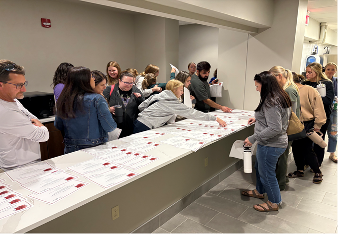 Grabbing certificates at Midwest Dental Study Club, DMF Campus - Fargo, ND